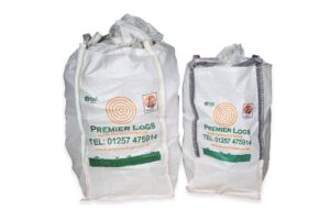 Premier Logs 1/2 Bulk Bag next to a Barrow Bag